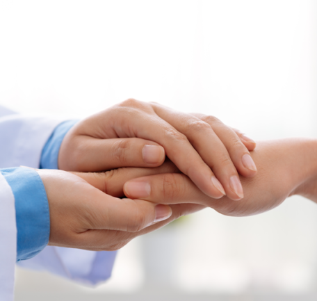 doctor-holding-patient-hand-edited-555x555